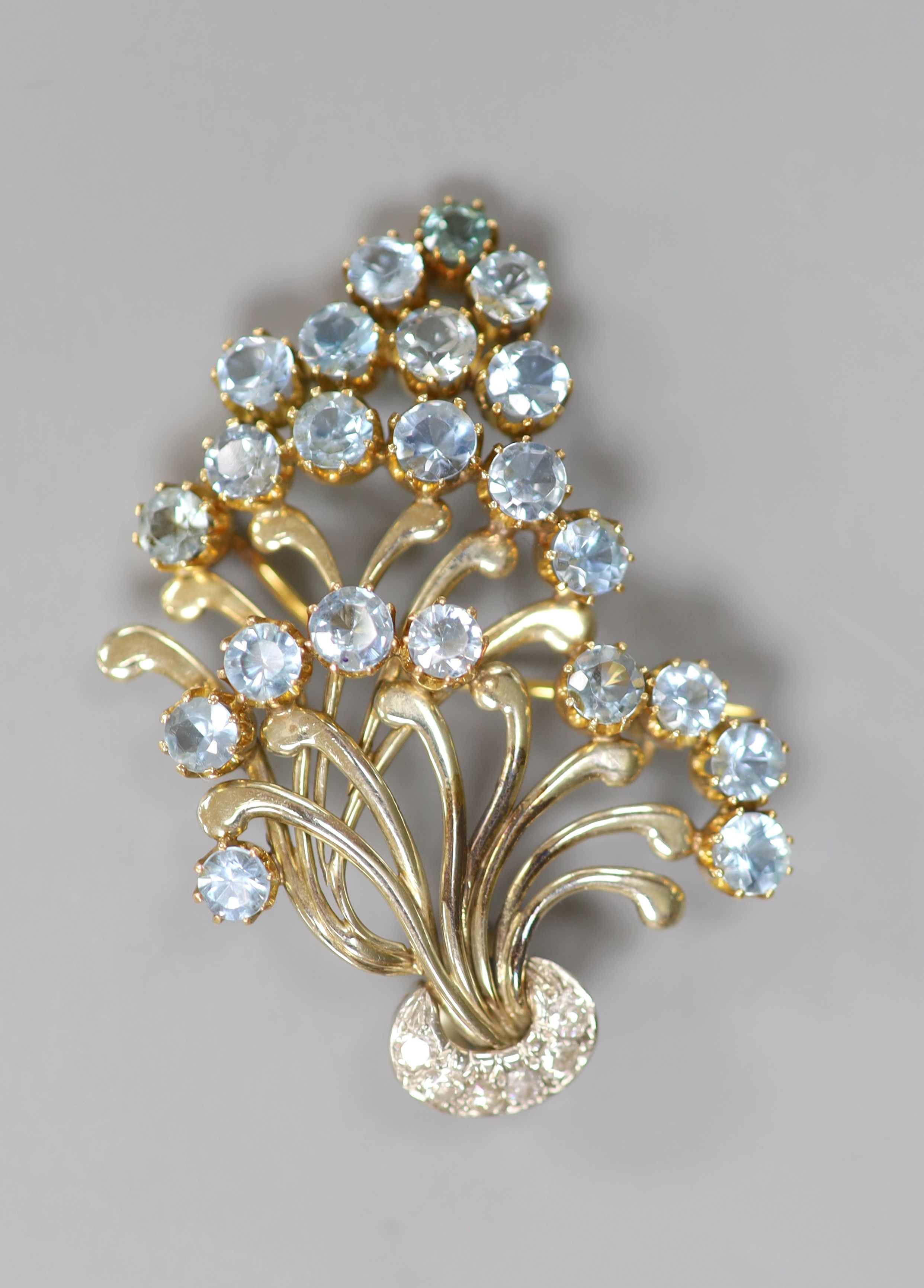 A 1950's yellow and white metal, aquamarine and diamond cluster set floral spray brooch